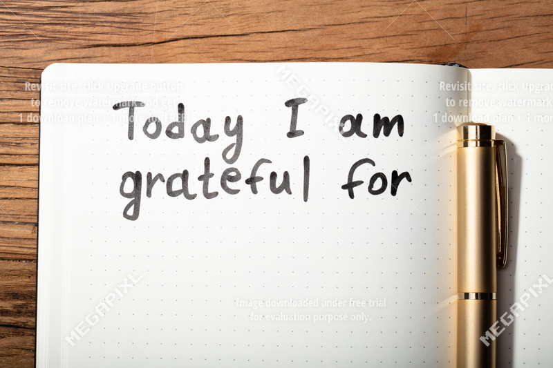 gratitude-word-with-pen-on-notebook-015610093830.webp